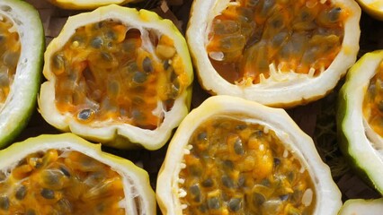 Wall Mural - Passion fruit background with half cut chinola, top view. A lot of sliced maracuja. Tropical fruits backdrop