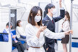 © maroke - マスクをして電車移動をする若い女性
