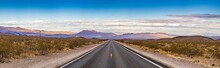 Panoramic Image Of A Lonely, Seemingly Endless Road In The Desert