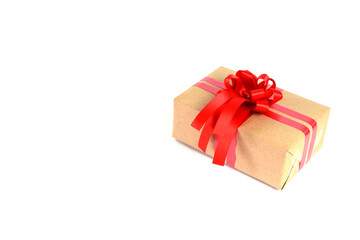 Brown craft gift box with red ribbon bow isolated on white background.