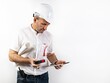 Male engineer in a white hard helmet. A middle-aged man in a white shirt, with blueprints, laser rangefinder and a tablet computer. Portrait on a white background. Male stock photo. Copy space