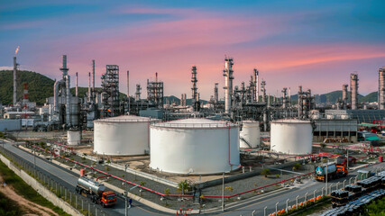 Wall Mural - Oil refinery plant at industrial zone, Aerial view oil and gas business petrochemical industrial, Oil refinery factory white oil storage tank and pipeline steel, Ecosystem and healthy environment.