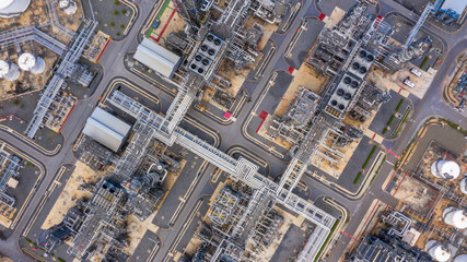 Wall Mural - Oil refinery plant at industrial zone, Aerial view oil and gas business petrochemical industrial, Oil refinery factory white oil storage tank and pipeline steel, Ecosystem and healthy environment.