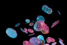 falling bitcoins with blue and pink light on dark background