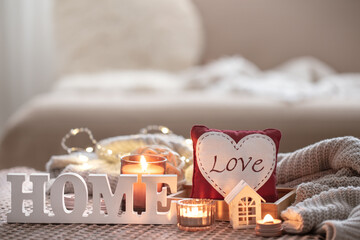 Wall Mural - Cozy Valentine's Day background with a candle and a decorative heart.