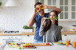 © BestForYou - Young couple in love, cooking together, having fun in the kitchen at home.