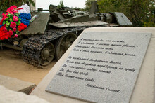 Carved Poems About War Against Background Of Destroyed Tank