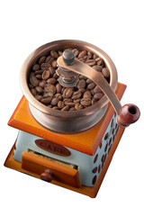 old-style manual coffee grinder and coffee grains in it, top view, isolated image on a white background