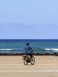 © Mounir - Man riding his bike on the beach