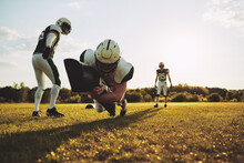 American Football Players Doing Tackling Drills On A Sports Field