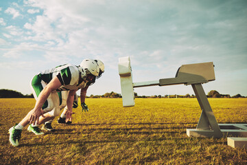 Wall Mural - American football players doing tackling drills on a sports field