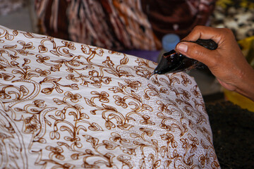 Wall Mural - The technique of making batik by writing using a canting tool. Canting consists of nyamplung, cucuk, gagang or handles made of copper, bamboo and wax. Cecek, loron, telon, prapat, telon, liman, byok.