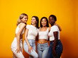 © iordani - diverse multi nation girls group, teenage friends company cheerful having fun, happy smiling, cute posing on yellow background, lifestyle people concept, african-american, asian and caucasian