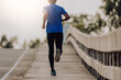 © sutadimages - Athlete runner feet running on road, Jogging at outdoors. Man running for exercise.Sports and healthy lifestyle concept.