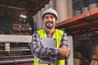 © anon - Engineer asian worker wearing safety helmet and vest holding clipboard and take note or tablet in the automotive part warehouse.Products and corrugated cardboard.