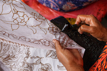 Wall Mural - The technique of making batik by writing using a canting tool. Canting consists of nyamplung, cucuk, gagang or handles made of copper, bamboo and wax. Cecek, loron, telon, prapat, telon, liman, byok.