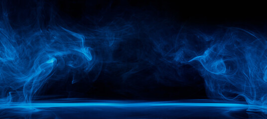 Wall Mural - Abstract blue smoke moves on black background. Swirling smoke.