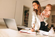 © Jacob Lund - Multitasking mom working in her home office