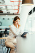 © PaeGAG - Young woman with tablet in coffee shop.