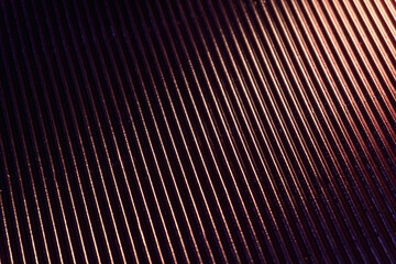 Wall Mural - Corrugated texture. Neon light background. Grooved metal surface. Golden blue color gradient glow reflection on parallel lines pattern dark black abstract overlay.