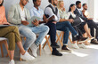 © Studio Romantic - Crop image of diverse employees sit on chairs in row listen to seminar or training in office. Job candidates or applicants in line wait for interview for vacant position. Employment, hiring concept.