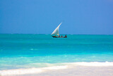 Fototapeta Tulipany - Traditional african sailboat in azure water of Indian ocean. Zanzibar, Tanzania