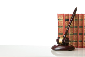 Wall Mural - Legal Law and Justice concept - Open law book with a wooden judges gavel on table in a courtroom or law enforcement office. Copy space for text.