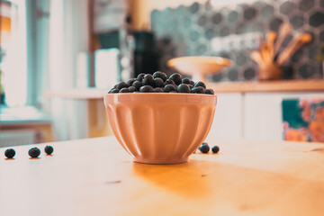 Wall Mural - bowl of fresh blueberries on rustic kitchen table