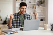 © Prostock-studio - Arabic man using laptop celebrating success shaking fists screaming yes