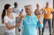 © Prostock-studio - Female fitness coach helping senior woman while exercising