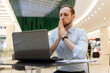 © vladdeep - Young businessman practicing breathing exhalation exercises working online to manage stress and calm down