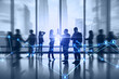 © Who is Danny - Businesspeople working together in bright office with abstract glowing polygonal network with people icons and blurry city view. Online networking, multimedia, digital communication concept.