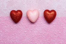 Simple Valentine's Day Background With Rextured Surface And 3 Red And Pink Hearts