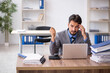 © Elnur - Young male employee unhappy with excessive work in the office