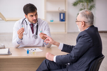 Sticker - Old businessman visiting young male doctor in vaccination concep