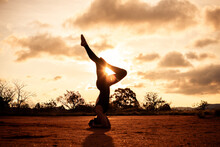 Woman Silhouette Doing Yoga At The Sunset.
