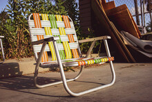 Colorful Retro Lawn Chairs On Concrete During Summer