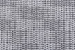 © New Africa - Grey knitted fabric as background, top view