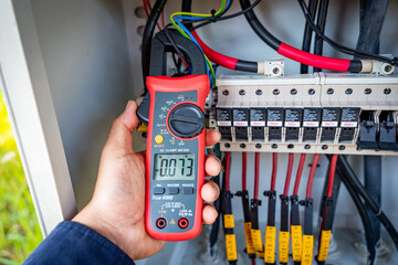 The solar farm(solar panel) with engineers use multimeter check the operation of the system, Alternative energy to conserve the world's energy, Photovoltaic module idea for clean energy production