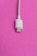 © Mateus - USB cable type C over pink background