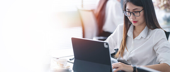 Portrait of beautiful entrepreneur businesswoman working on laptop computer in modern office.