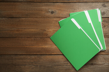 Wall Mural - Light green files with documents on wooden table, top view. Space for text