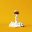 © aanbetta - Burger rocket and smoke on yellow background. Creative idea. Minimal fast food concept. 3d rendering