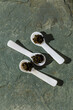 Black Caviar in special Shell Spoon on gray stone slate background texture