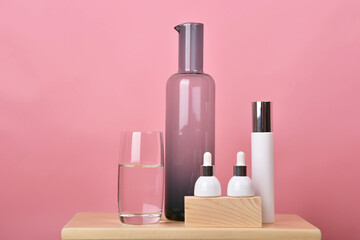 Wall Mural - Cosmetic bottle container on pink background, Blank label for branding mock-up.