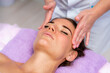 © svetograph - Relaxing massage. European woman getting facial massage in spa salon, side view