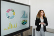 © Westend61 - Young businesswoman with hands clasped giving presentation in board room