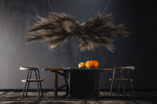Three Dimensional Render Of Pampas Grass Hanging Over Wooden Table With Pumpkins On Top