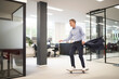 © Westend61 - Businessman skateboarding in modern office