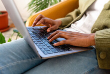 Freelance Typing On Laptop Keyboard At Home